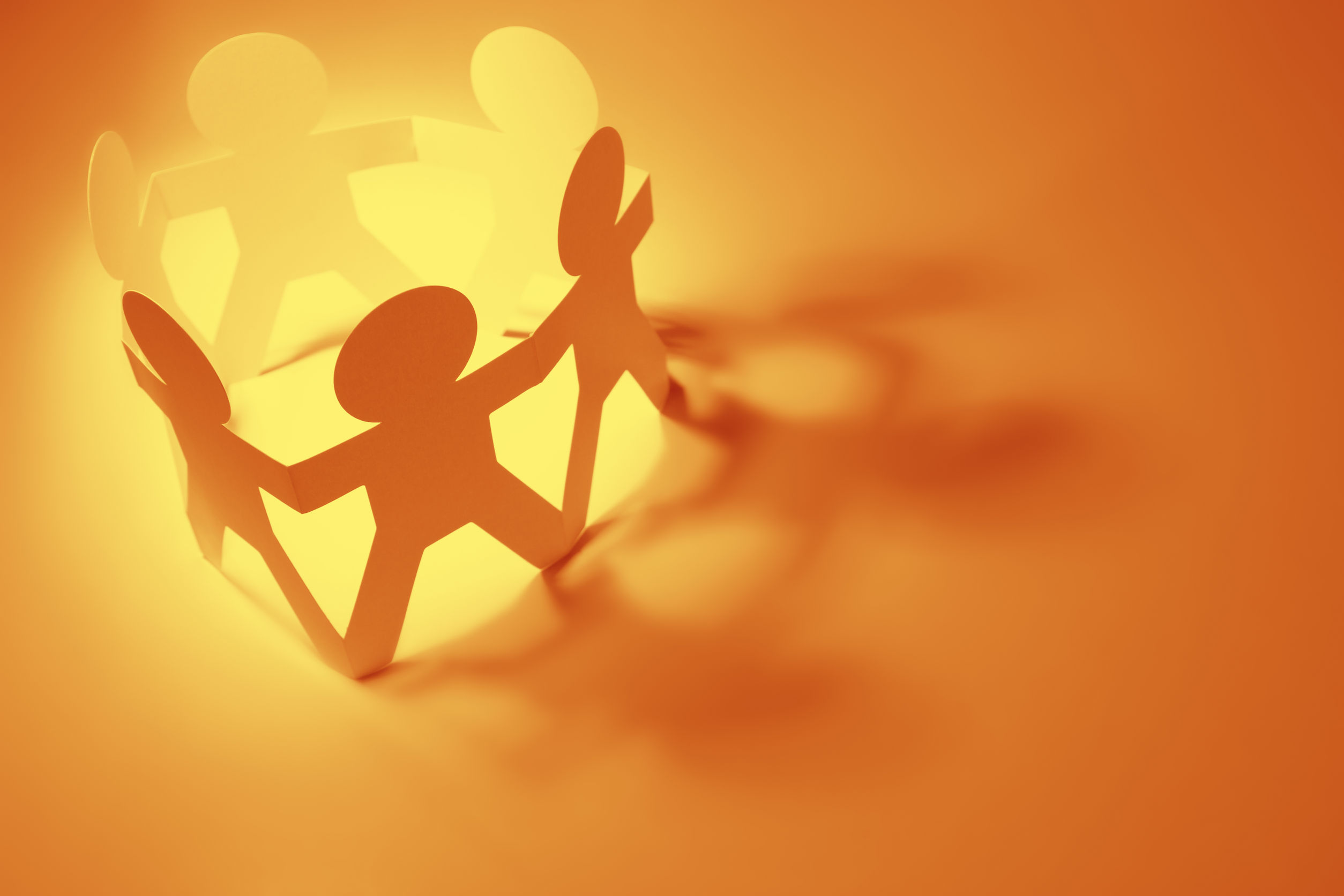 Photo of paper doll cut-outs forming a circle and holding hands Photo of paper doll cut-outs forming a circle and holding hands